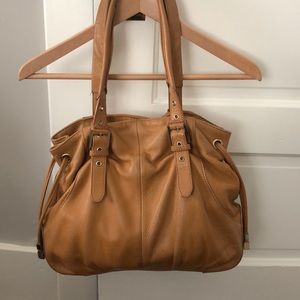 Pour La Victoire leather purse with buckles.